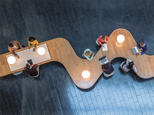 Panoramic overhead view of several business meetings