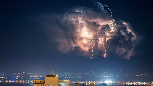 Storm with lightning over the city at night